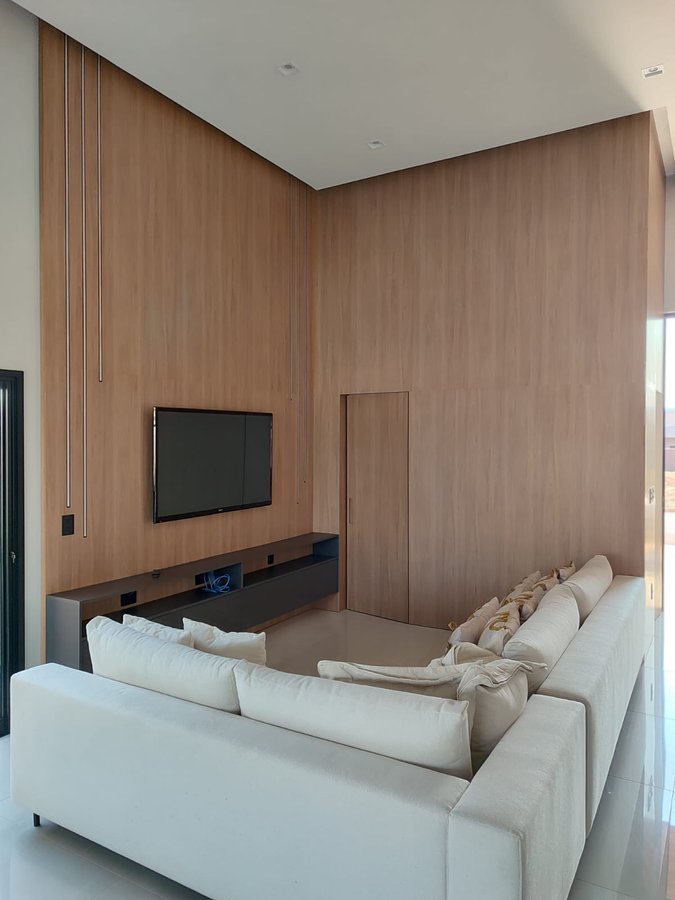 Sala de estar com painel de madeira planejado, projeto MR Móveis Planejados